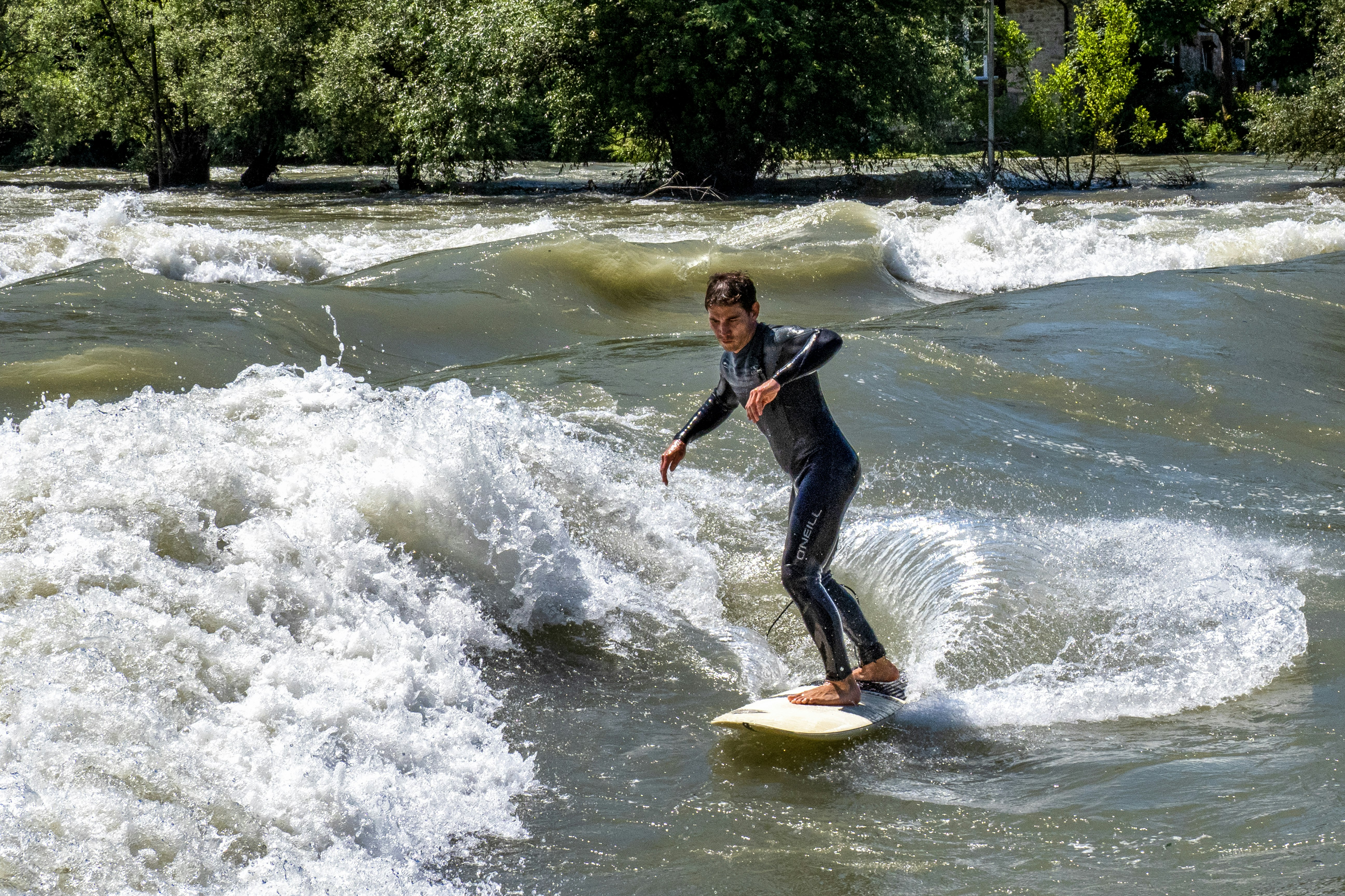 woman in black wetsuit riding yellow surfboard on water during daytime